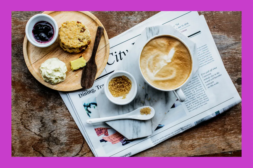 Cup of coffee on top of a newspaper