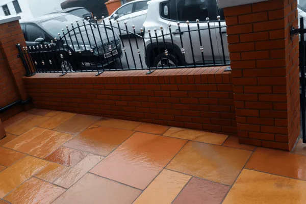 We built this red brick wall with pillars and black metal rails inbetween them