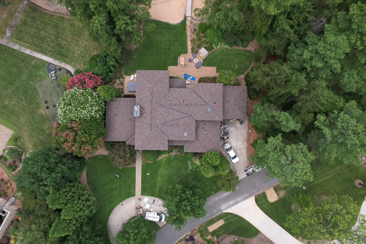 Multi-gabled luxury residence in Millsboro with expert shingle roof installation featuring proper valley construction, ice-and-water shield protection, and seamless integration with skylights, highlighting Your Neighbor's Contractor's attention to detail for discerning homeowners in Delaware's premier neighborhoods.