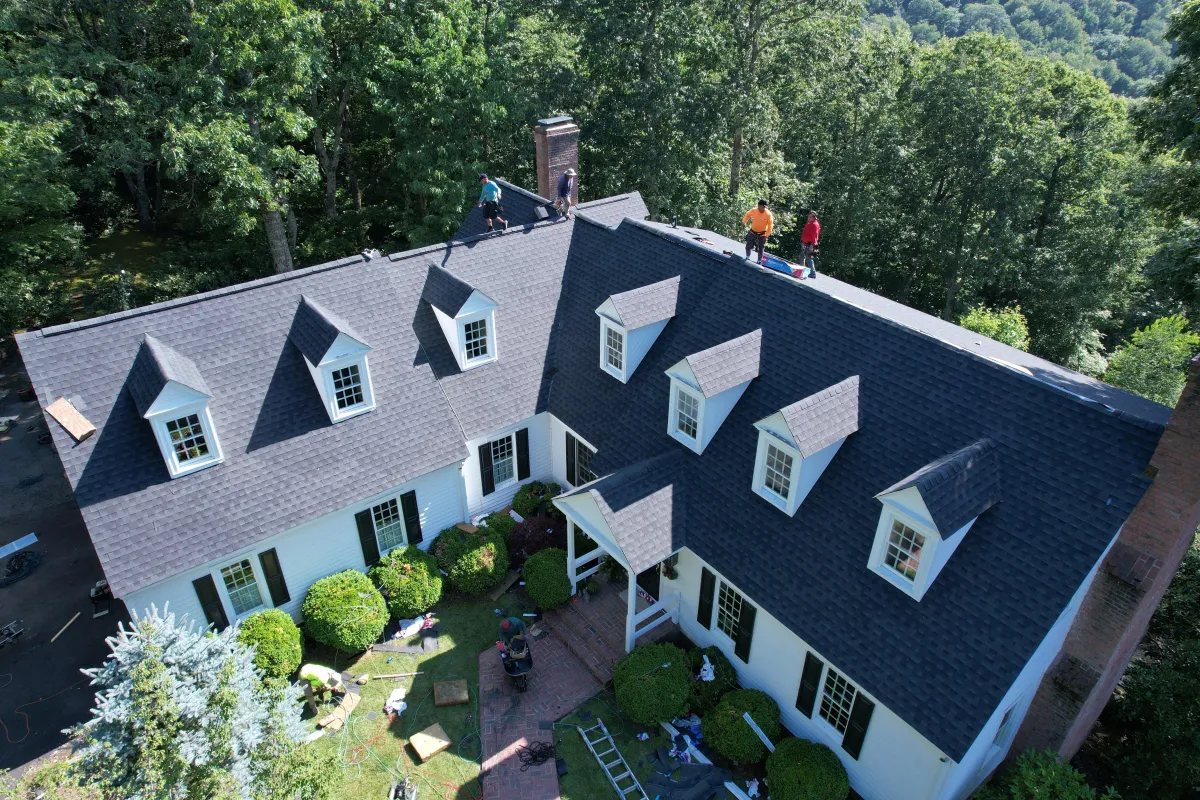 Recently completed designer shingle roof replacement on a Sussex County luxury property, showcasing dimensional Owens Corning Duration shingles in a custom color blend that enhances the home's architectural features while providing superior weather resistance and a 50-year warranty.