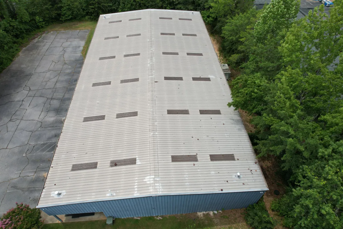 Commercial metal roofing installation in Delaware showing weather-resistant features that protect business investments with a 50-year warranty.