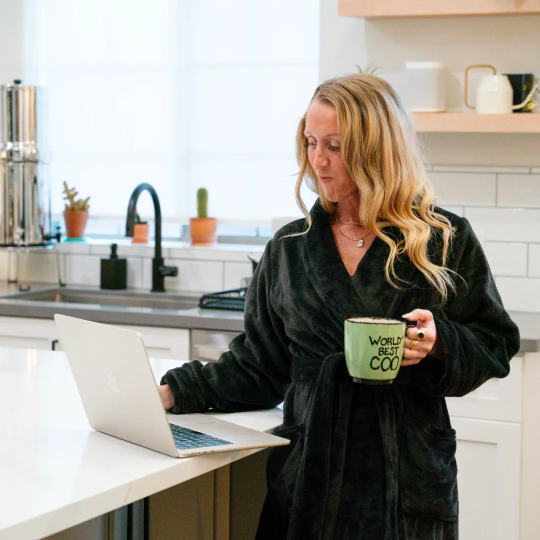 Melissa Dlugolecki, business coach and consultant, standing in a professional setting.