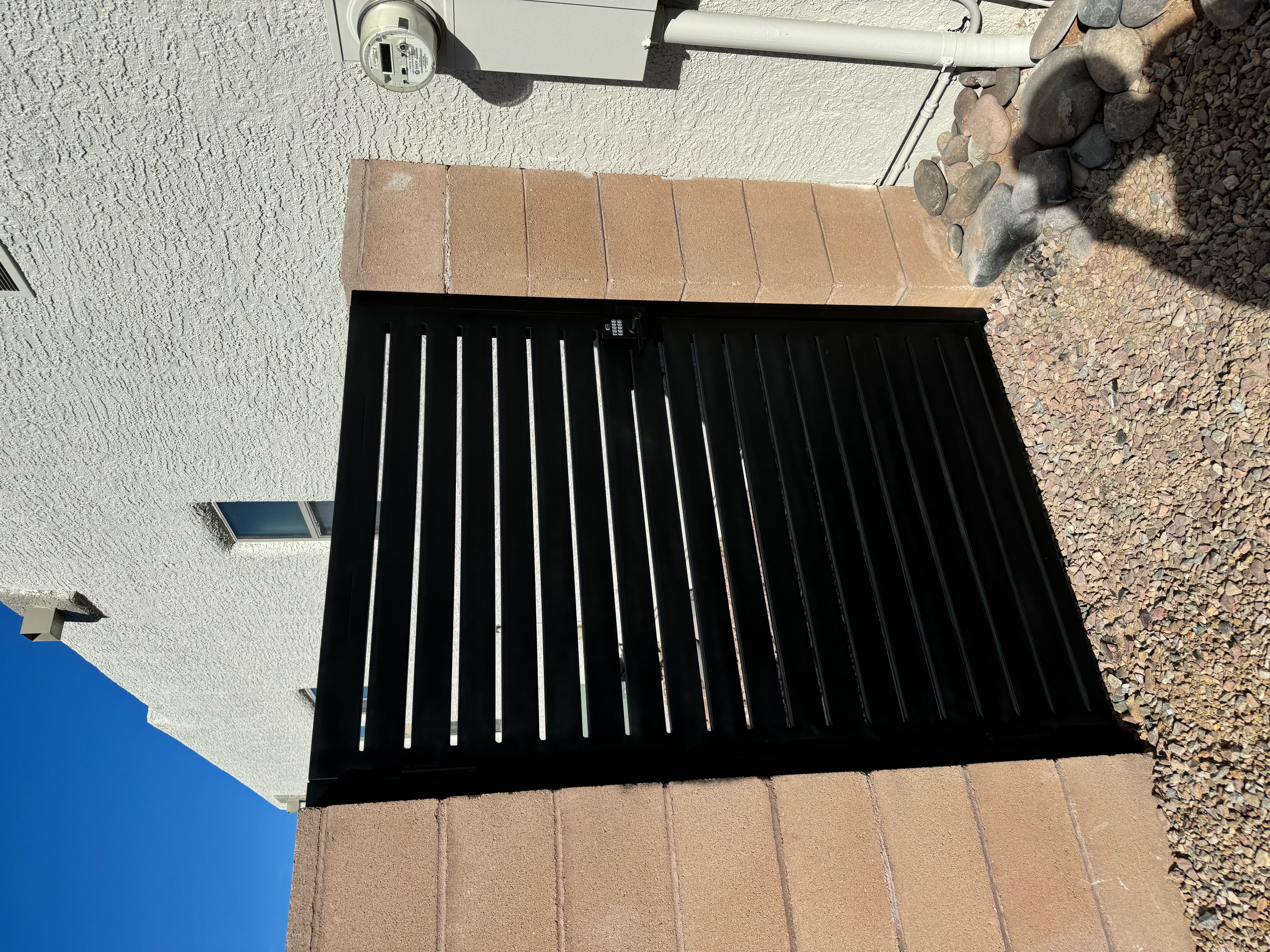 "Repaired iron gate with intricate design, showcasing Walker Mobile Welding's residential welding expertise in Tucson, AZ.