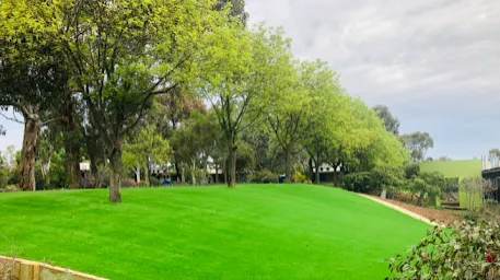 Residential landscaping construction with retaining wall and lawn