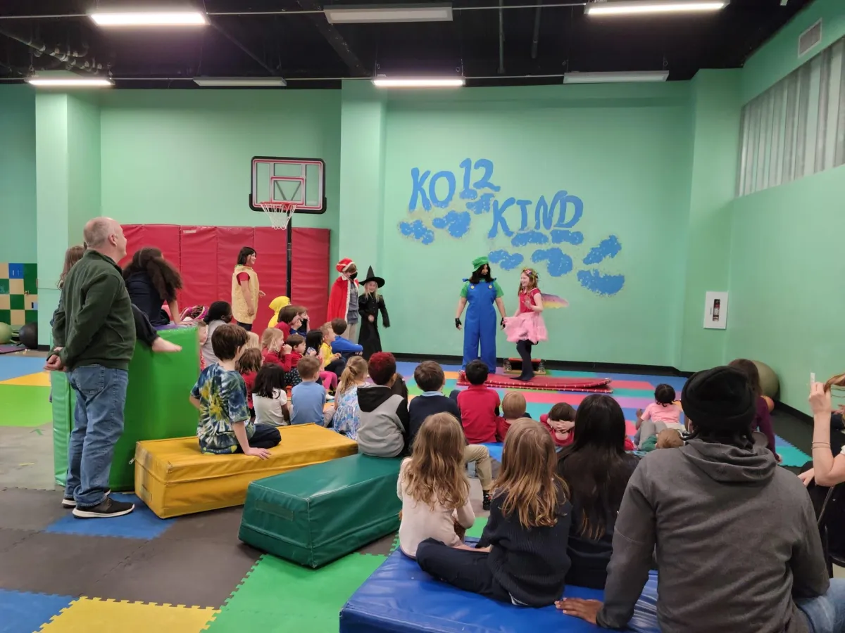 picture of ko12 kids students putting on a costume performance for the school.