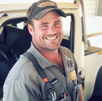 one of the owners of dynasty garage doors in his garage door work wear