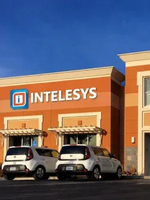 Intelesys building exterior with prominent logo, showcasing technology solutions provider's commitment to client success and proactive IT support.