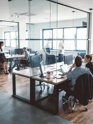 Team reviewing a security dashboard with shield icons on screen