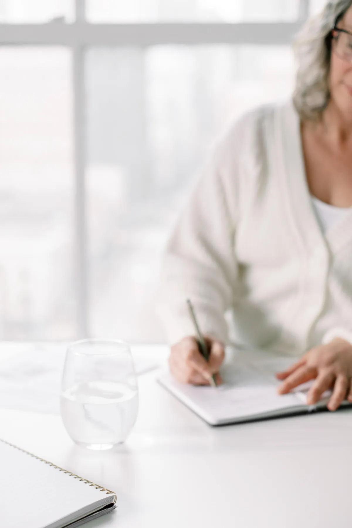 Woman sitting at a table writing