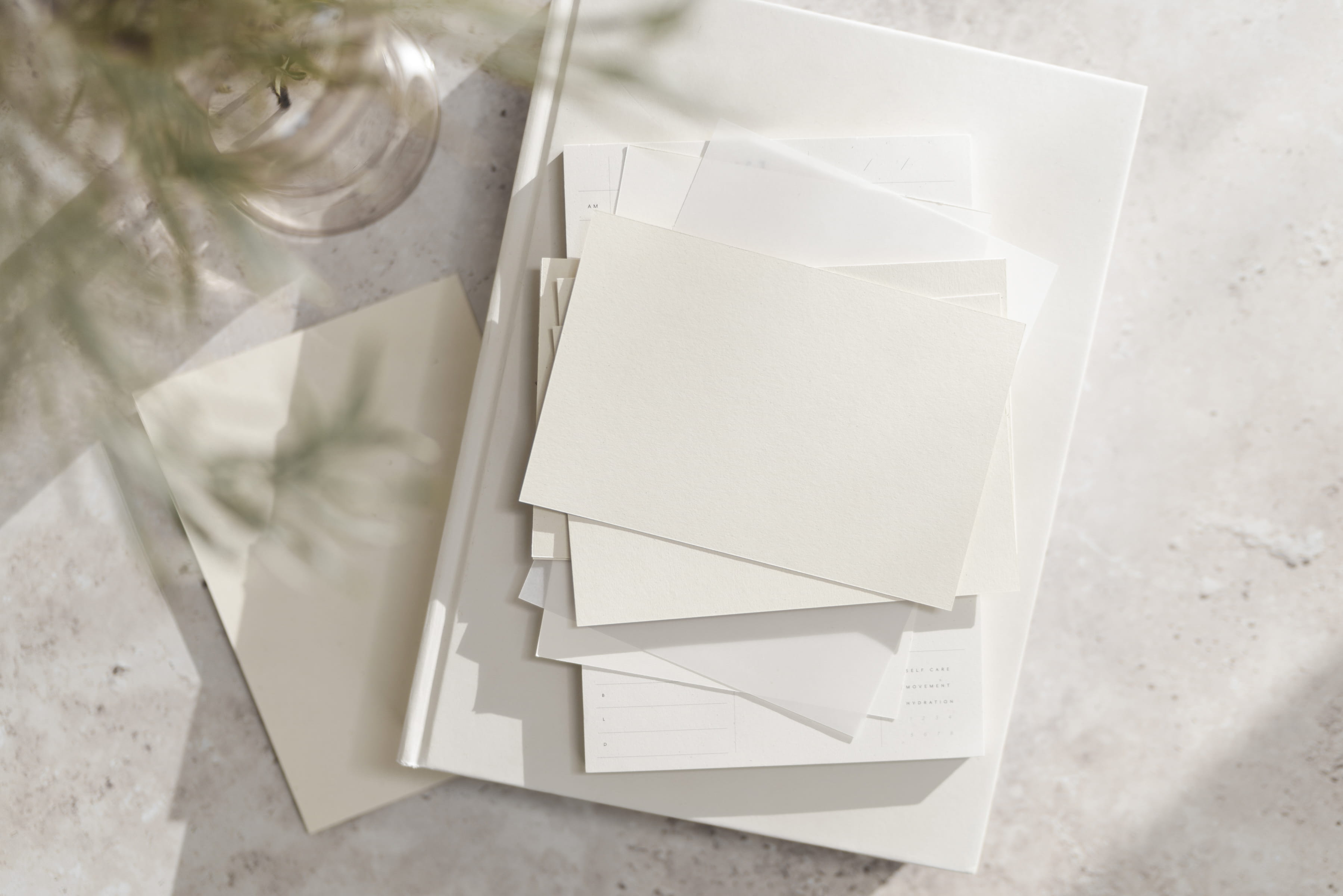 Message into Motion photo of pencils, keyboard, and open notebook on a white table.