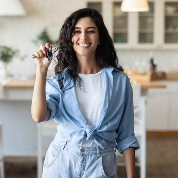 woman holding keys to house