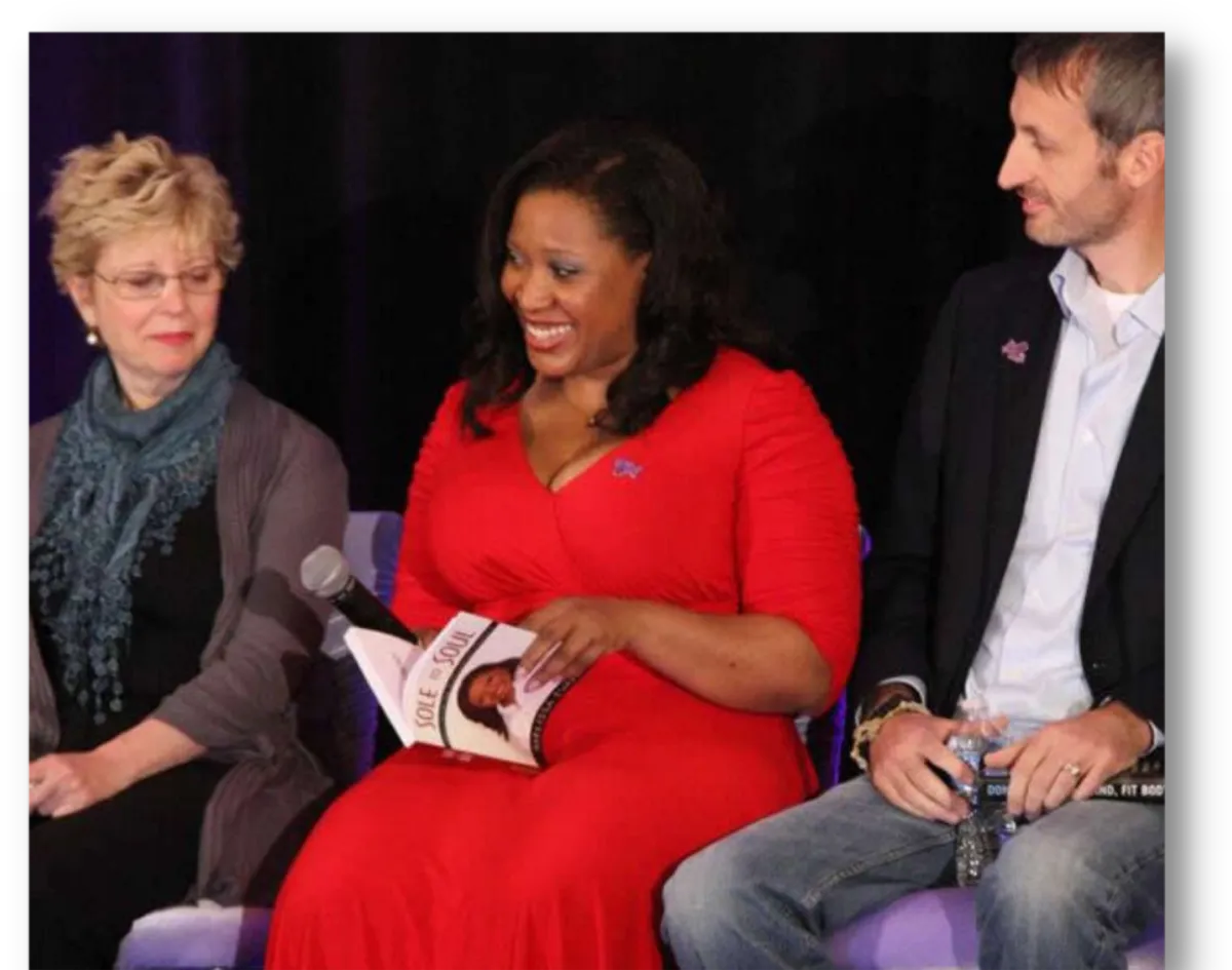 Melissa Hughes holding her bestseller book.