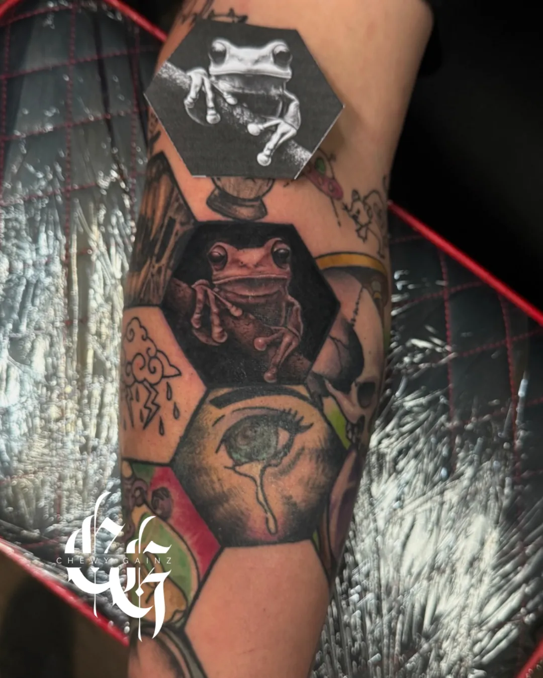 Black and grey stipple-shaded lioness tattoo on the upper thigh, featuring fine-line botanical elements and high-contrast realism and surrealism styling by a professional tattoo artist in Warren, Ohio.