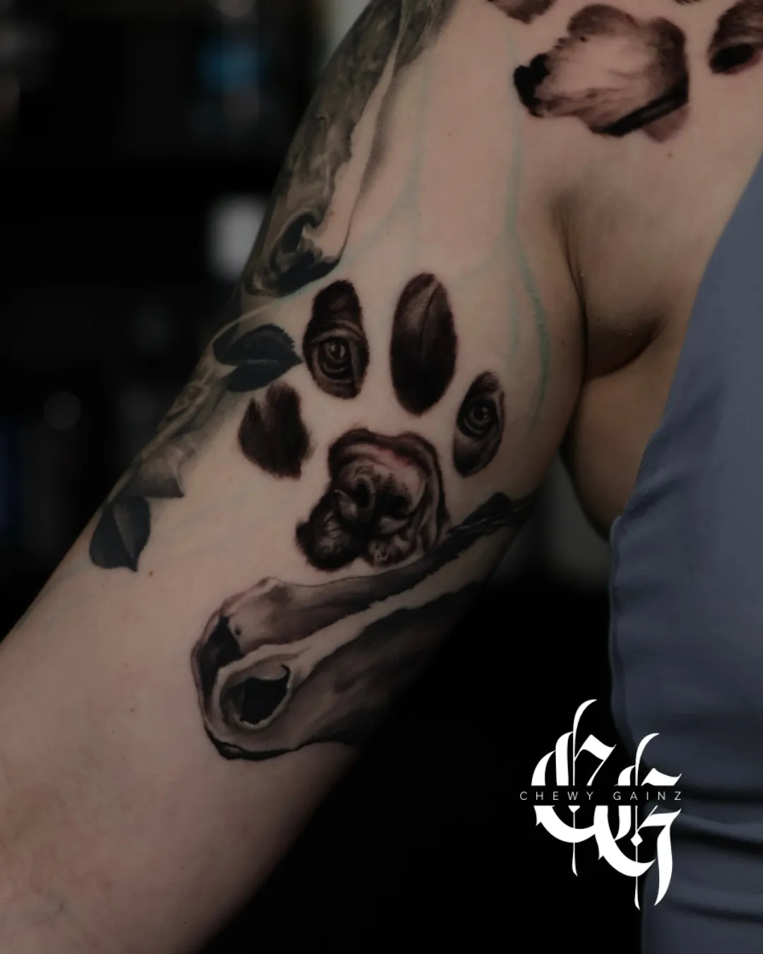 Black and grey realism and surrealism lower-leg tattoo featuring a detailed football and stadium scene with dramatic lighting and high-contrast shading, created by a professional tattoo artist in Warren, Ohio