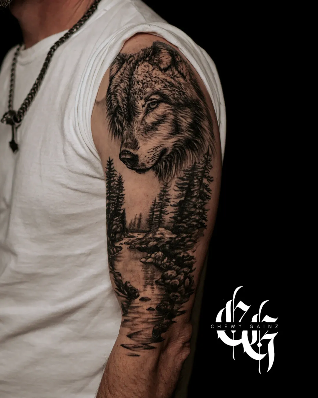 Black and grey realism and surrealism tattoo artist in Warren, Ohio tattooing a client’s upper chest, creating a high-contrast black and grey realism piece with fine detail and clean shading inside a professional studio.