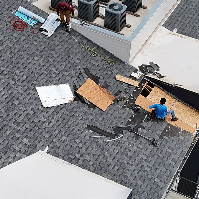 Missing shingles on a roof after a wind storm in Pflugerville, Texas