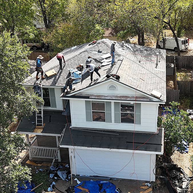 Roofing crew installing a roof on a Leander home