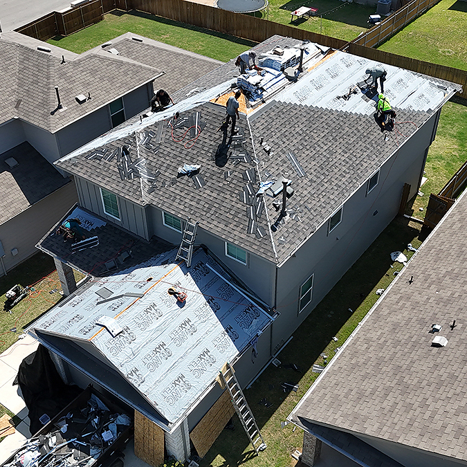 Roofing crew installing a roof on a Lakeway home