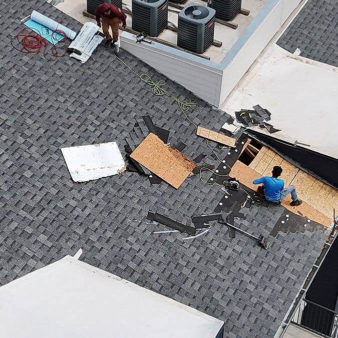 Missing shingles on a roof after a wind storm in Forest Creek, Texas