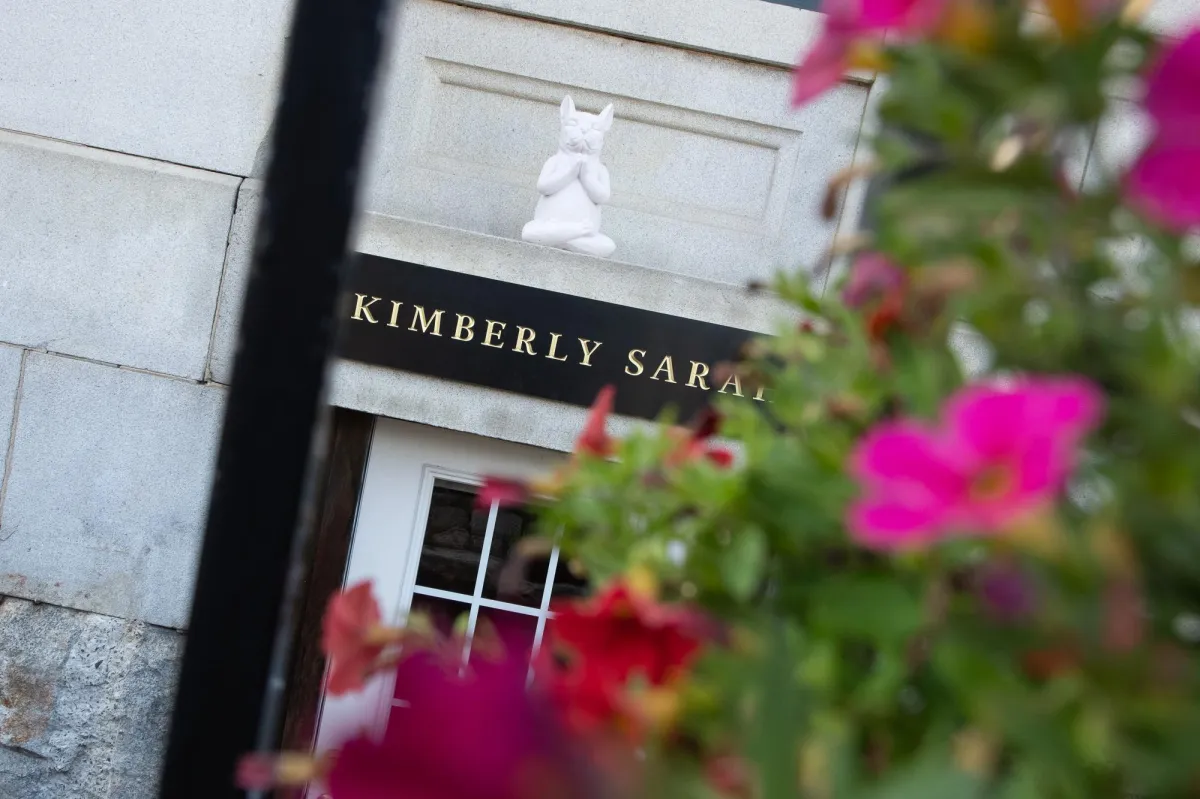Kimberly Sarah Photography sign at the Customs House in Portsmouth NH with flowers in foreground
