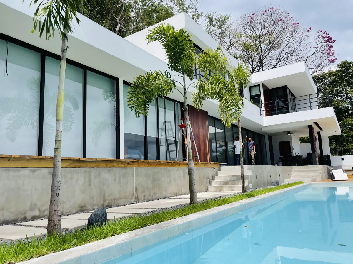 a rendering of a modern house with palm trees