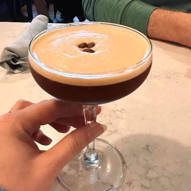 Craft espresso martini topped with coffee beans at Rushing Trading Co. in Johns Creek, GA