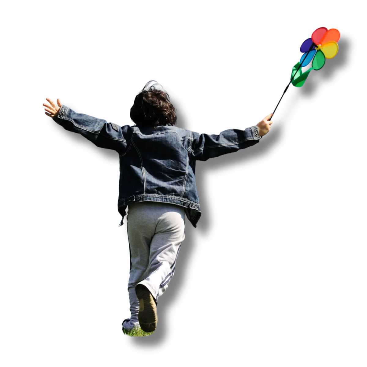 Child joyfully running outdoors with arms raised, symbolizing active real-life engagement.