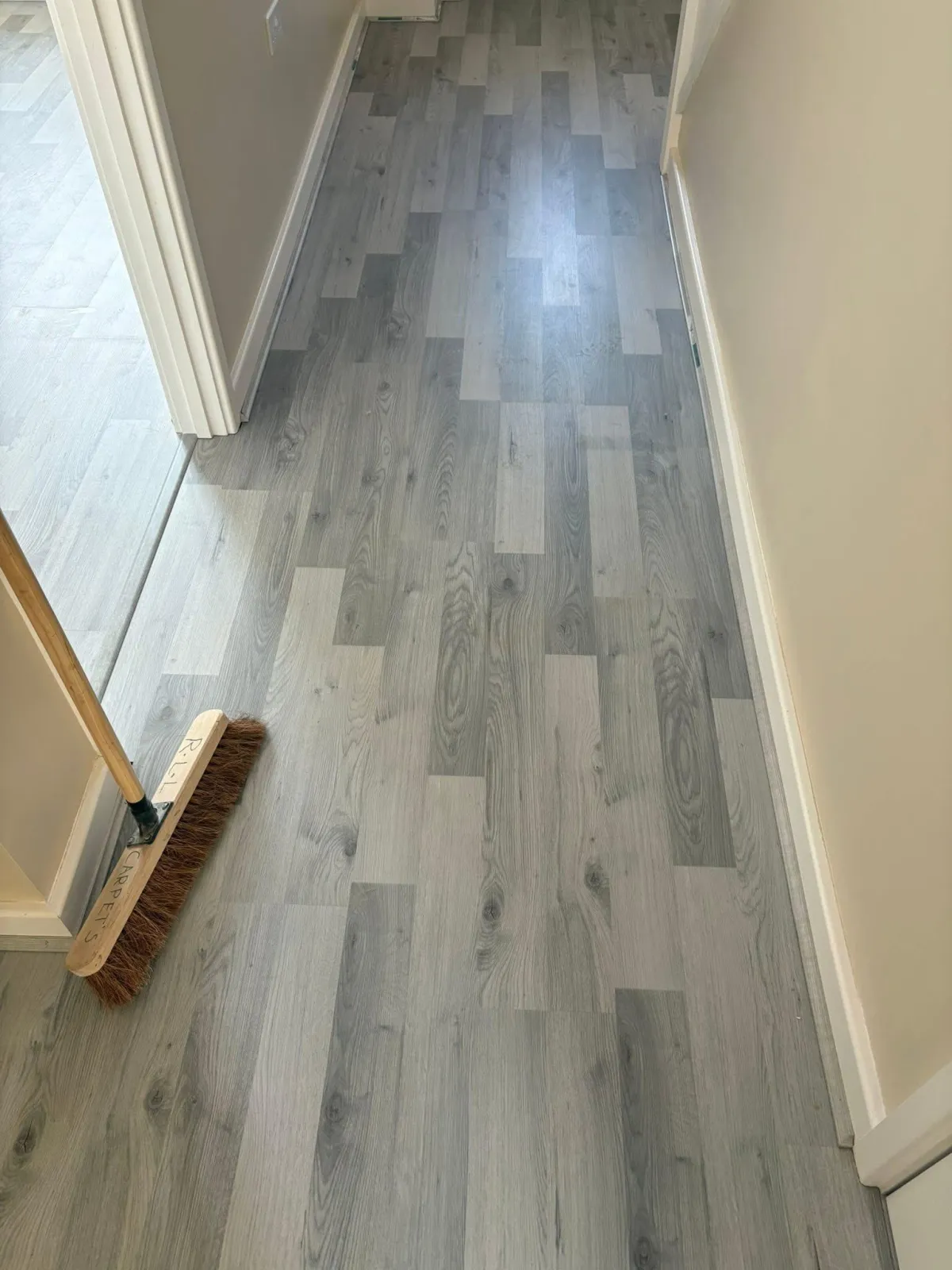 Stylish vinyl flooring in different shades of grey, lining a hallway