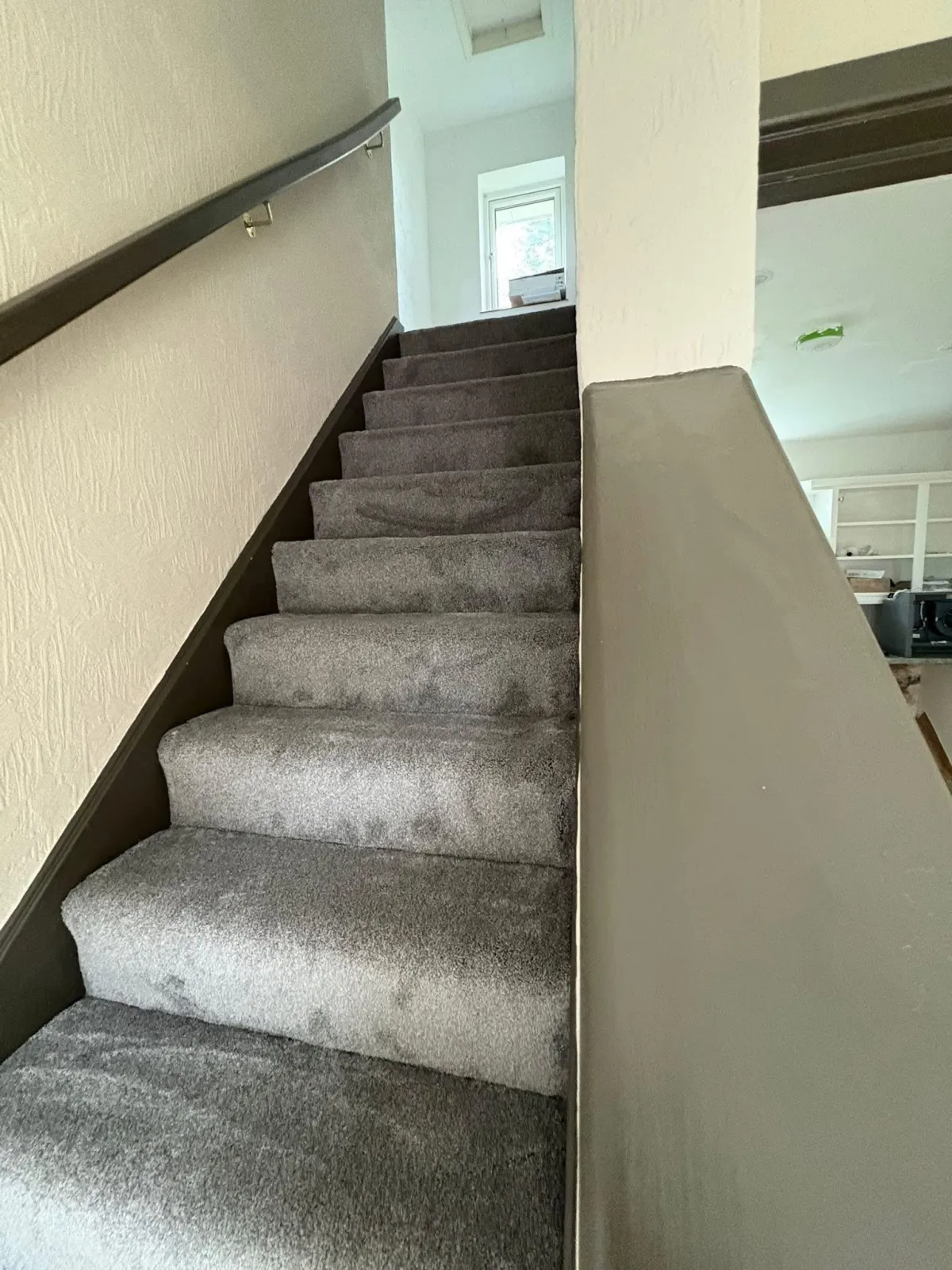 Freshly fitted carpet flowing up a set of stairs 