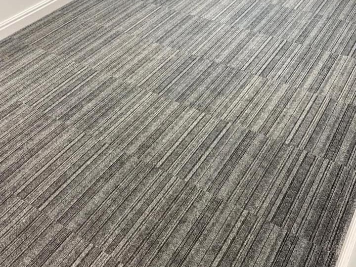 Mixed shades of grey carpet tiles freshly installed