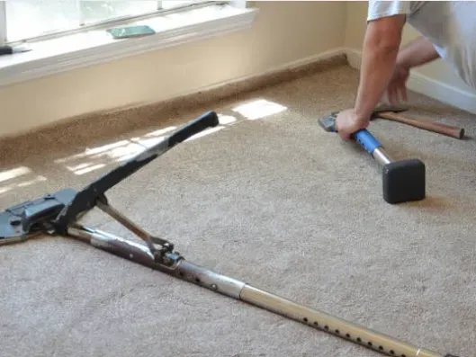 A RLL Carpet and Flooring team member fitting a new carpet for a customer
