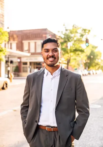 Shawn Gee standing in front of scenic buildings in Baton Rouge