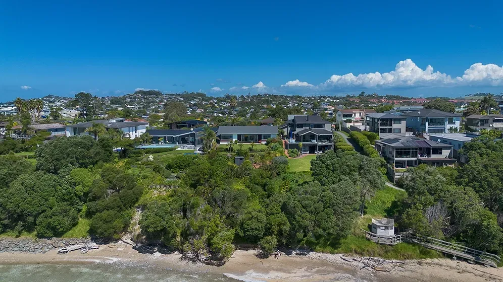 Aerial drone photo of a coastal Auckland property on a clear day for a real estate listing