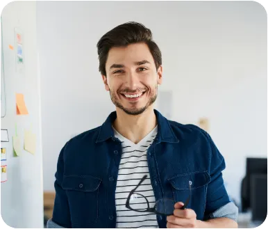 Image of a smiling male in a office environment representing impactful design and content creation.
