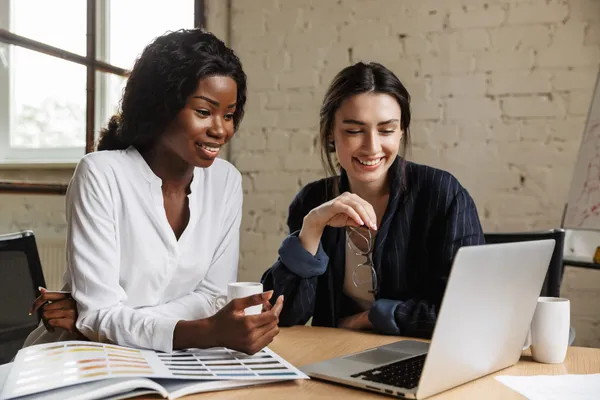 Two entrepreneurs collaborating on a business growth strategy with AOWork2Live.