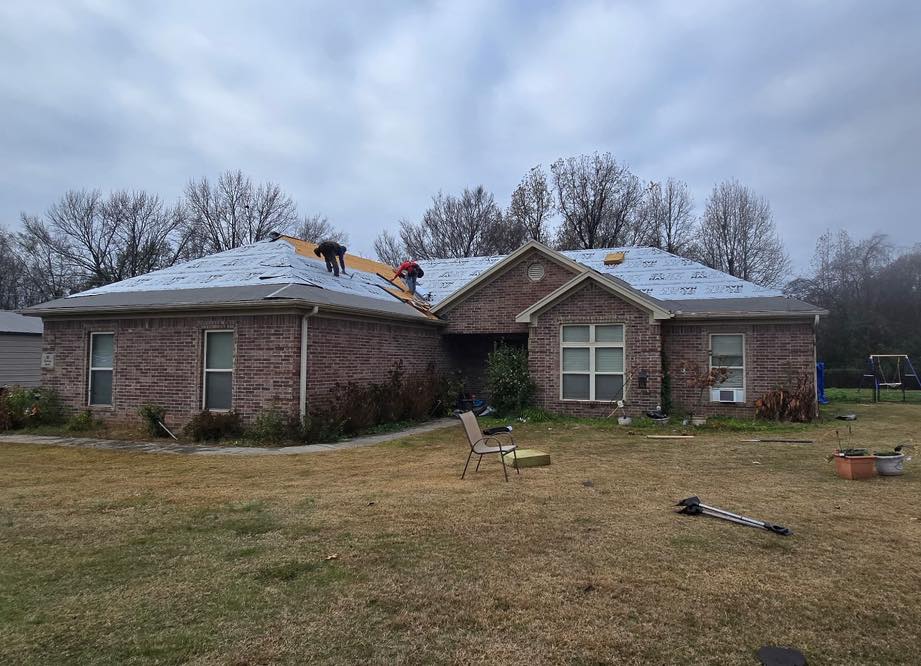The roof of a building with a tree in the background