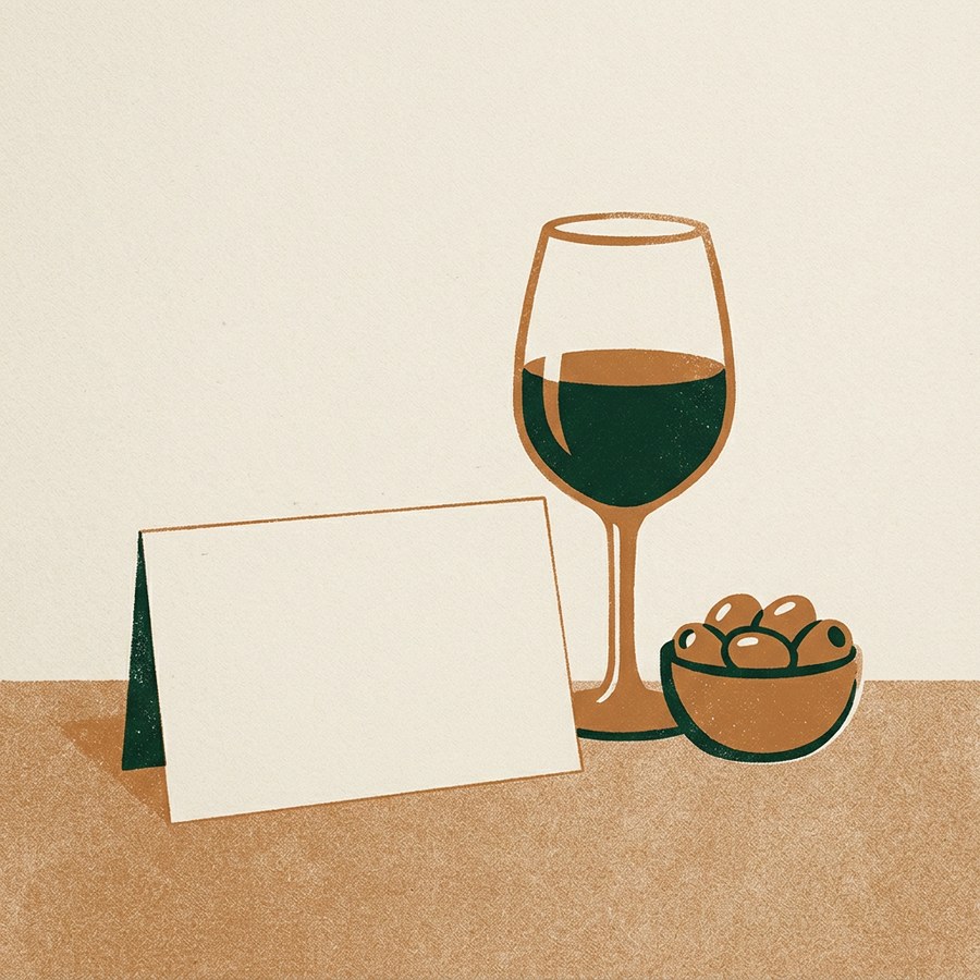 A card and a glass of wine