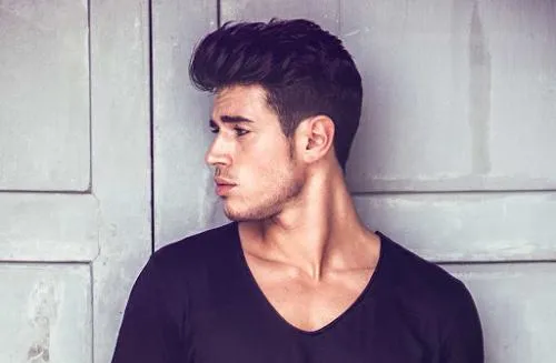 Messy top hairstyle with low fade for modern look