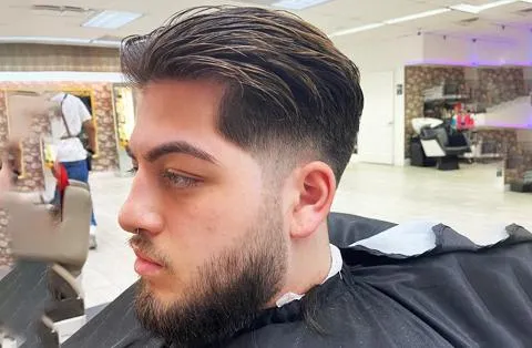 Men’s hairstyle with side part and high fade