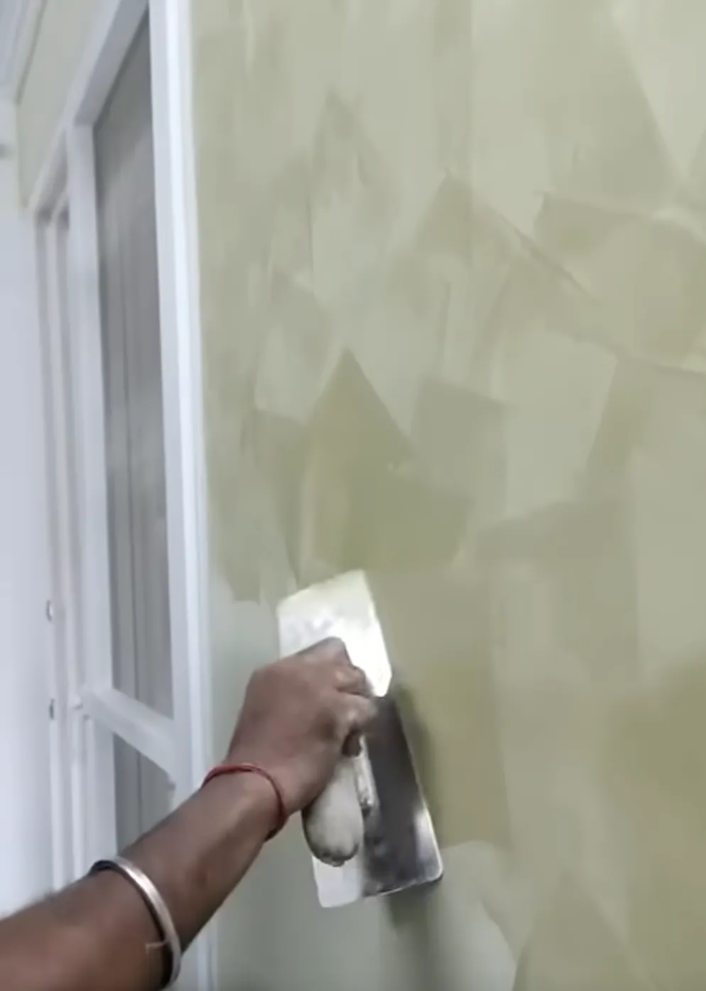 Man applying a stucco finish to a wall