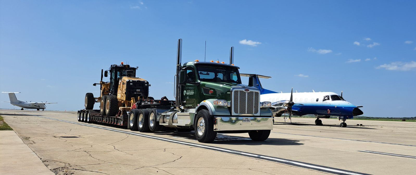 Red bolt cutters resting on a concrete wall.