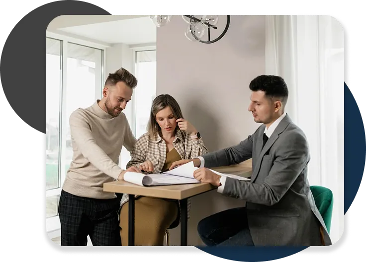 Couple meeting with advisor to review documents.