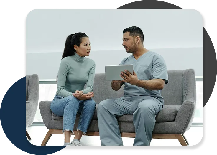 Doctor discussing health information with a patient on a tablet.