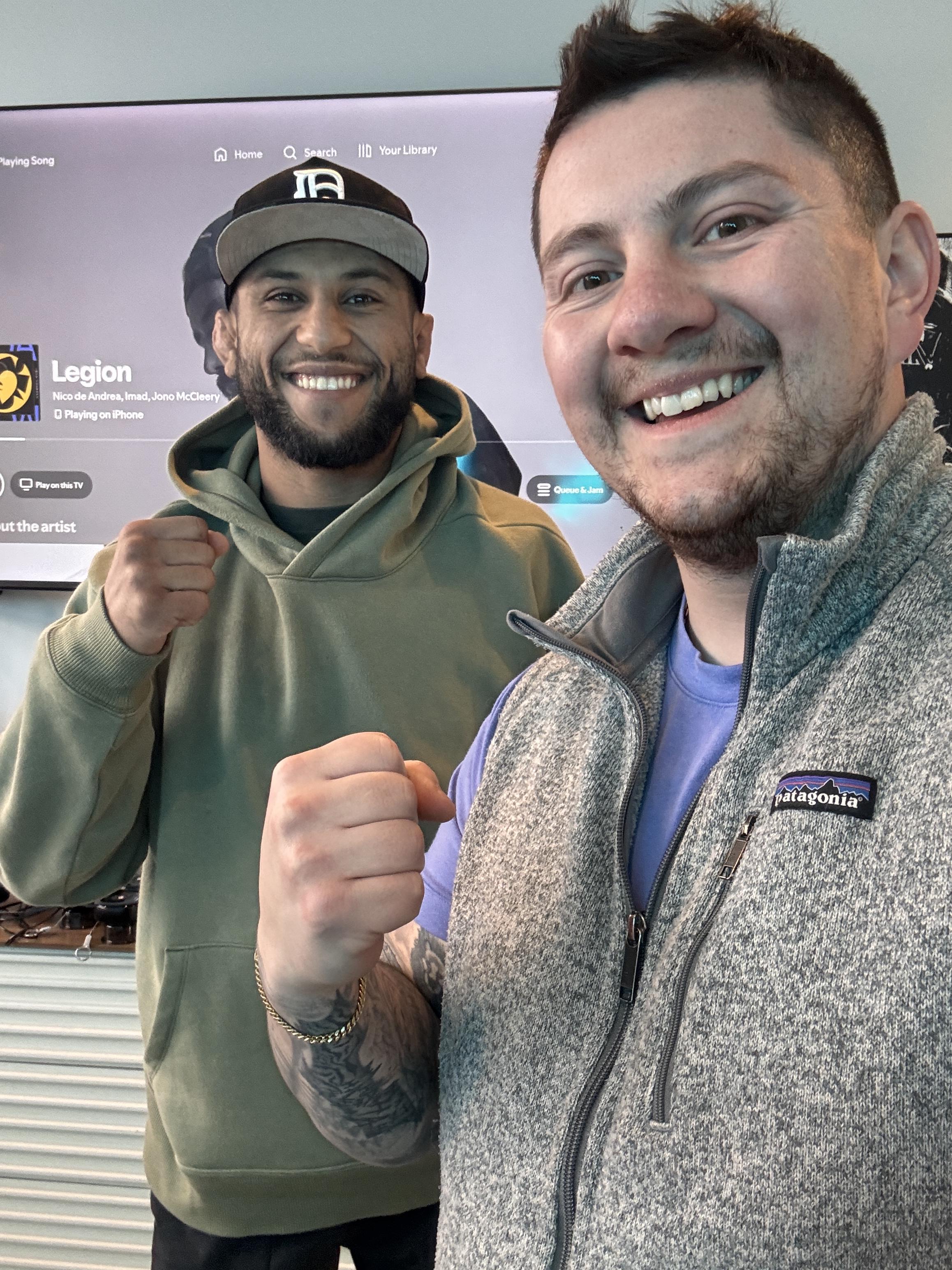 A smiling middle-aged woman sitting comfortably in a bright living room, holding a yoga mat. She appears relaxed and content, symbolizing improved mobility and well-being after chiropractic care. The background is softly blurred, focusing on her positive expression.