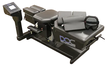 A diverse adult patient receiving gentle spinal decompression therapy from a professional chiropractor in a modern, sunlit clinic. The patient appears relaxed and hopeful, with the practitioner focused and reassuring. The background features soft blue and white tones, evoking calm and trust.