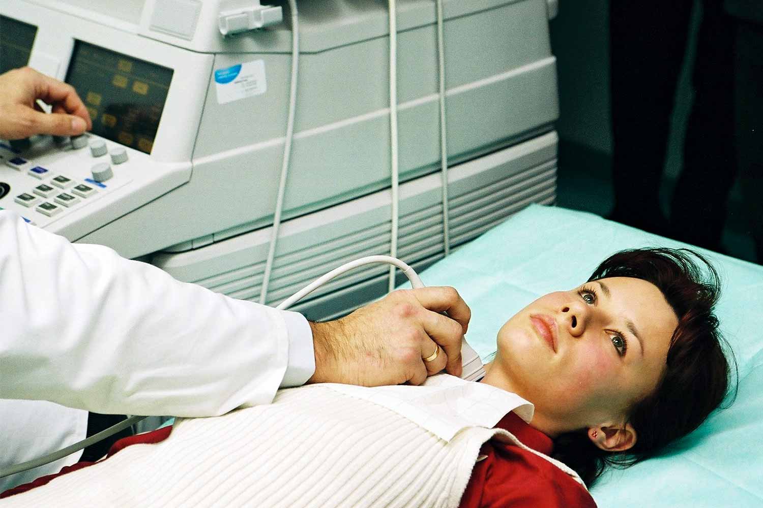 patient having an echocardiogram procedure performed with a technician and machine.