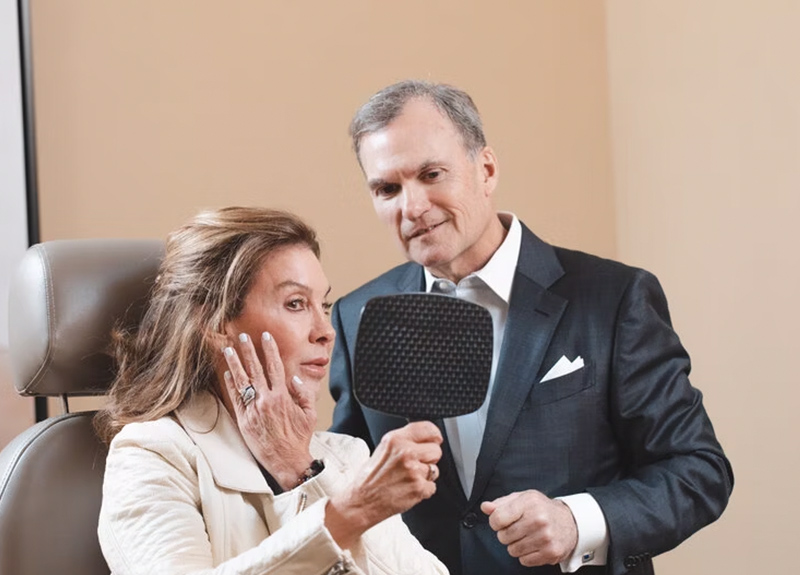 person in white dress shirt wearing green and white hat