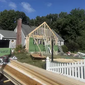 Home addition sheathed and roofed on a cape-style house in Worcester, MA by ARM Construction