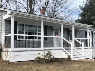 Farmer's porch with columns and railings, built by ARM Construction in Boylston, MA