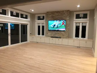 Great room addition with a stacked stone feature wall and built-in cabinetry, by ARM Construction in Worcester, MA